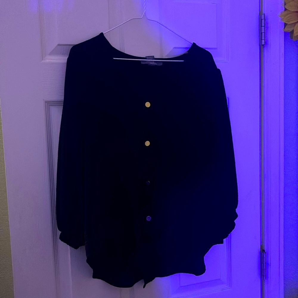 Black top with tie at the bottom and gold buttons down the front